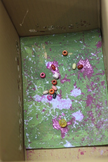 pony beads and paint in a cardboard box