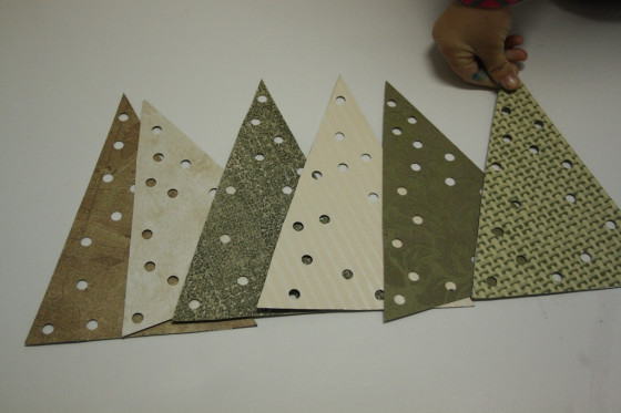 holes punched in triangles for lacing tree ornaments 
